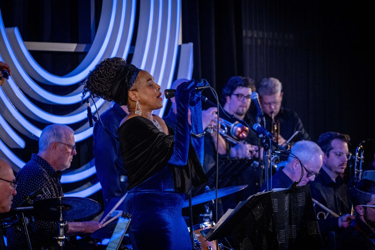 Live jazz vocalist performing on stage at Dazzle Denver with full band